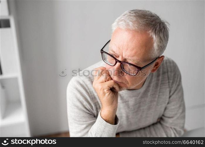 old age, problem and people concept - close up of senior man in glasses thinking. close up of senior man in glasses thinking