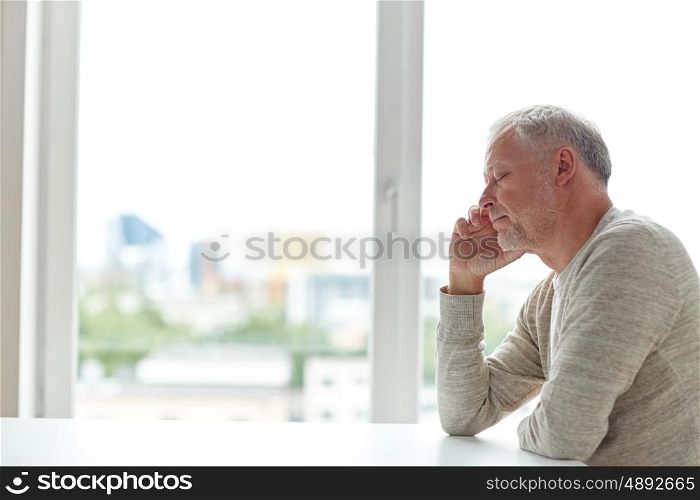 old age, problem and people concept - close up of senior man thinking