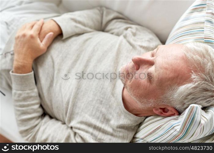 old age, rest, comfort and people concept - close up of senior man sleeping on sofa