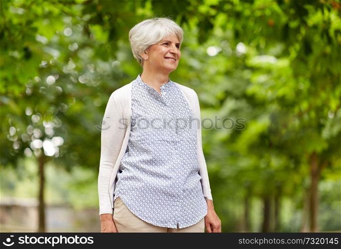 old age, retirement and people concept - happy senior woman at summer park. happy senior woman at summer park