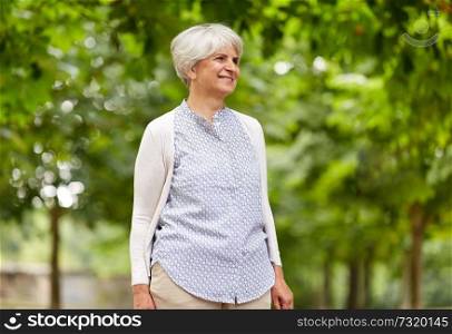 old age, retirement and people concept - happy senior woman at summer park. happy senior woman at summer park