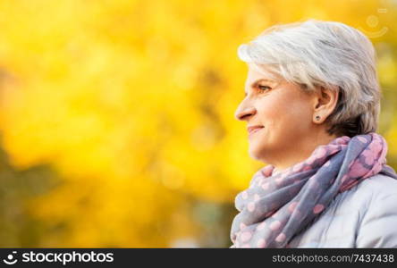 old age, retirement and people concept - portrait of happy senior woman at autumn park. portrait of happy senior woman at autumn park