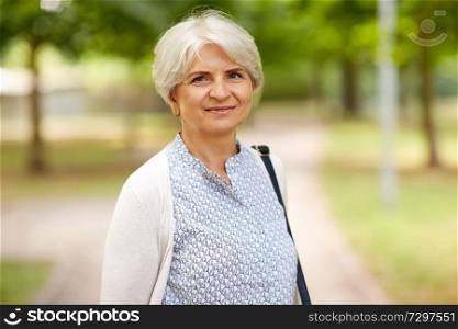 old age, retirement and people concept - portrait of happy senior woman at summer park. portrait of happy senior woman at summer park