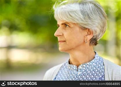 old age, retirement and people concept - portrait of senior woman at summer park. portrait of senior woman at summer park