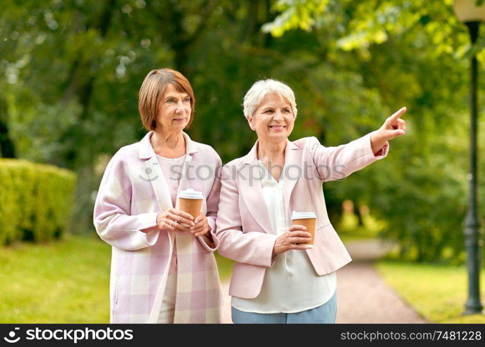 old age, retirement and people concept - two senior women or friends drinking coffee at summer park. senior women or friends drinking coffee at park