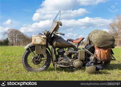 Old american military motorcycle parked on grass for exhibition in nature