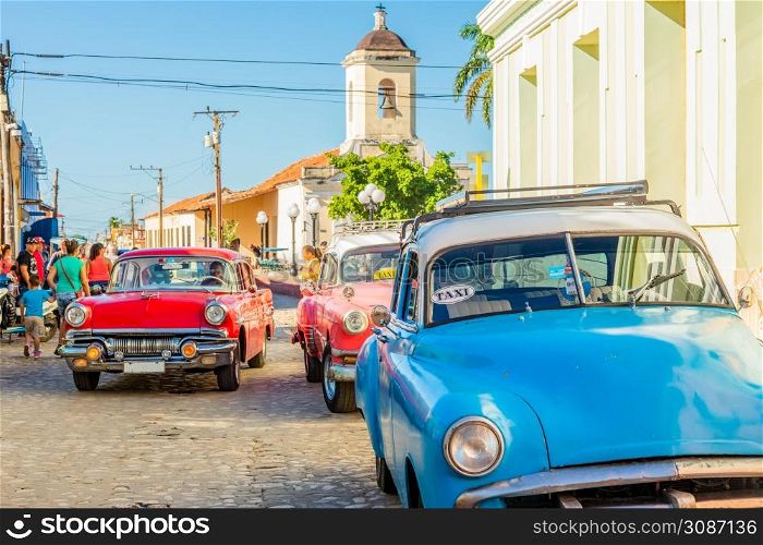 Old american retro cars in historical center of Trinidad, Cuba