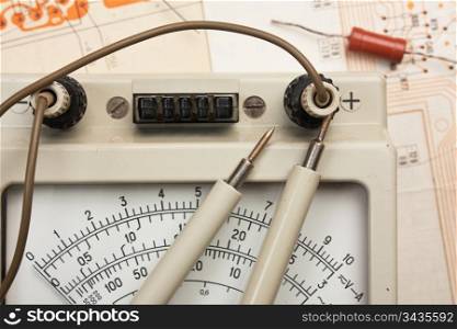 old analog multimeter and electronic component