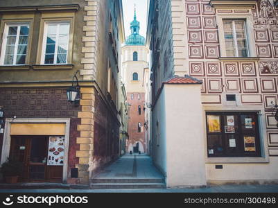 Old ancient polish architecture. Colorful houses as a part of center of the Warsaw. Beautiful church on narrow street