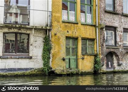 Old and colorful houses on the edge of a canal of Belgian ghent