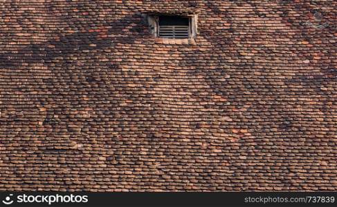 Old and ruined roofs. Texture of a roof with old roof tiles.