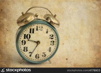 old and rusty alarm clock isolated on vintage background