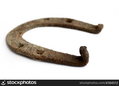 old and rusty horseshoe isolated on white