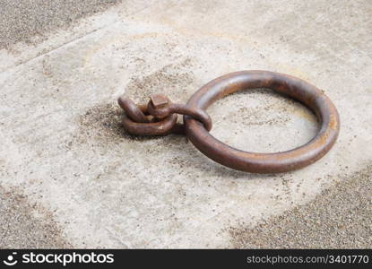 old and rusty mooring ring for ships on dock