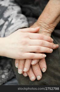 Old and young hands. Hands of the old woman - 84 years covered with young hands