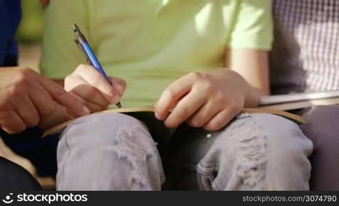 Old and young people together, elderly and children in family, generations with child and senior persons. Grandpa and grandma help grandson with school homework, studying with book, education