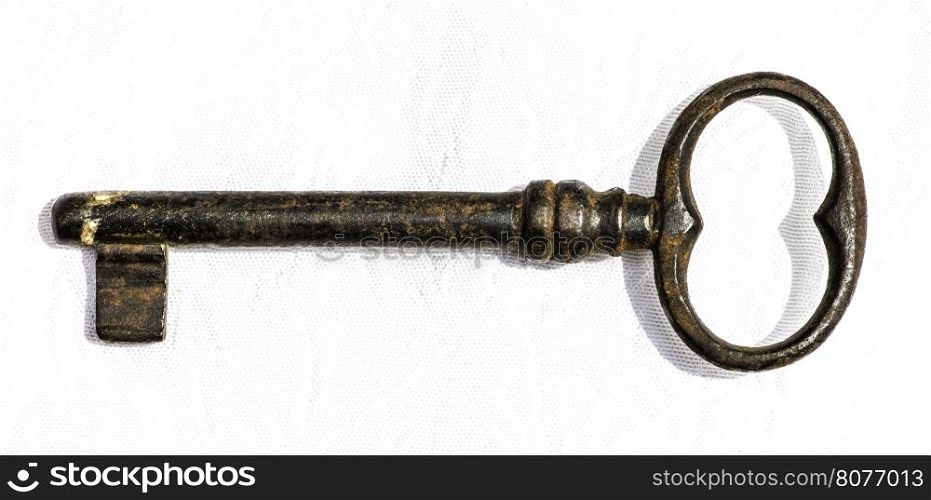 Old antique key on white