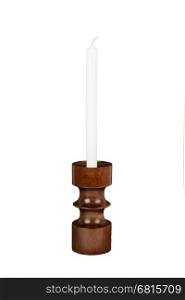 Old antique wooden candlestick candleholder with vintage candle isolated on white