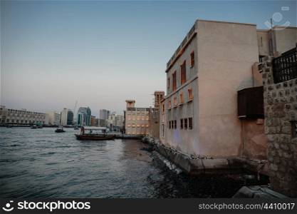 Old Arab houses on the waterfront of the Gulf Creek in Dubai, twilight