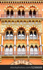 old architecture in london england windows and brick exterior wall