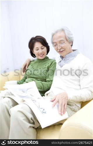 Old asian couple reading