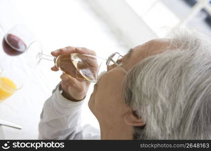 Old asian man drinking