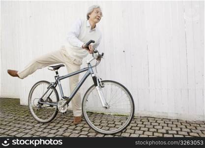 Old asian man on a bike
