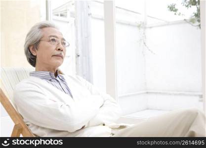Old asian man sitting in a chair