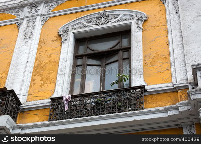 old balcony window and yellow wall