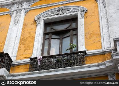 old balcony window and yellow wall