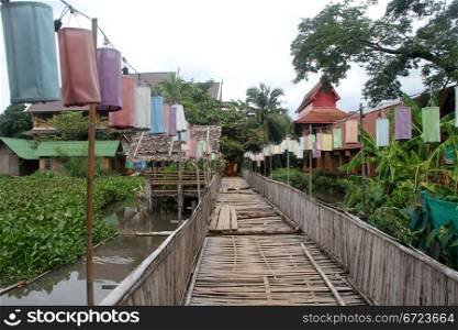 Old bamboo bridge and row of lamps in Chiang Mai, Thailand