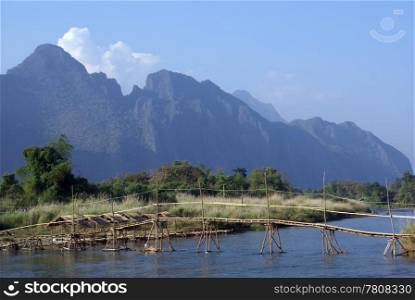 Old bamboo bridge on the river in Laos