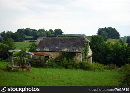 Old barn on the farm field in France