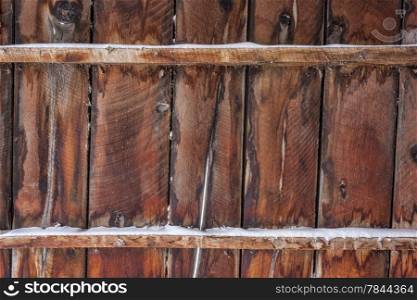 old barn wall or fence with some snow - weathered wood background