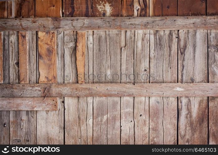 old barn wall with vertical planks - weathered wood background
