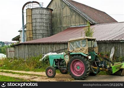 old barn with silo and tractor