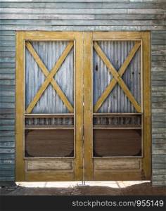 Old barn wooden bracing frame with zinc sheet double door.