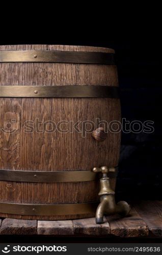 Old barrel with vintage tap on wooden table still life