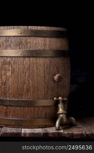 Old barrel with vintage tap on wooden table still life