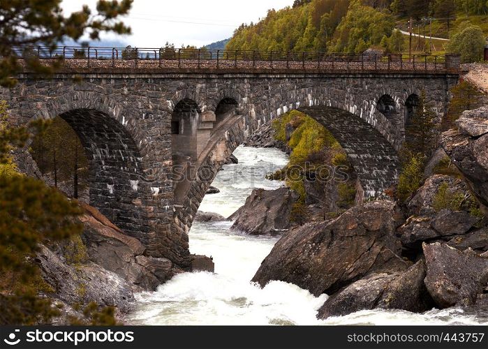 old beautiful arched brick bridge in the Norwegian mountains, Norway