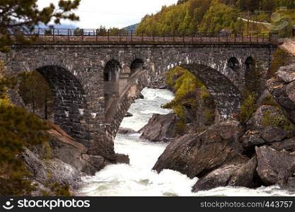 old beautiful arched brick bridge in the Norwegian mountains, Norway
