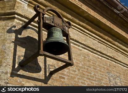 old bell hanging from a church wall