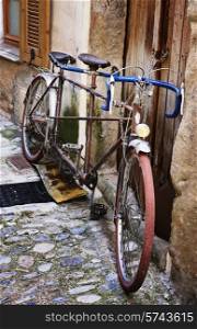 Old bicycle on a medieval street in France
