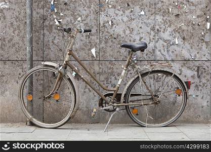 Old bike in front of a weathered wall