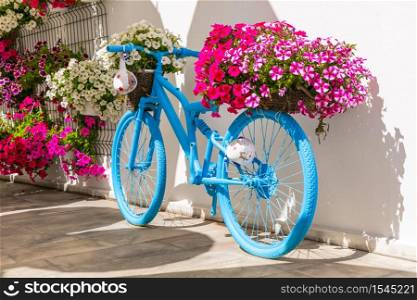 Old bike with flowers - street or garden decoaration ideas. Vintage bike - floral decoration