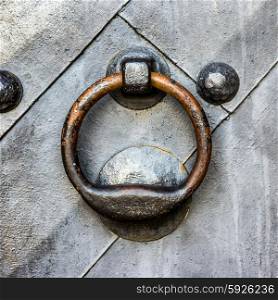 Old black metal door in temple gate with ring knocker