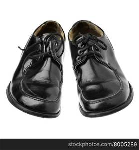 Old black shoes isolated over the white background