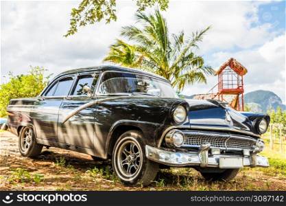 Old blcak american retro car parked in Vinales, Cuba