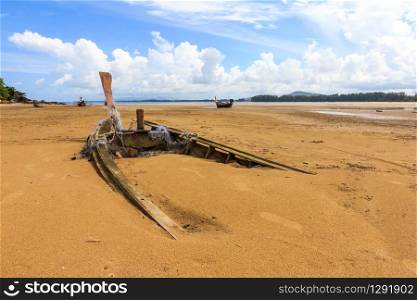 Old boat buried in the sand, Nai Yang beach, Phuket, Thailand