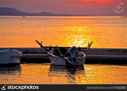 Old boat on golden sunset view, Sukosan bay in Croatia